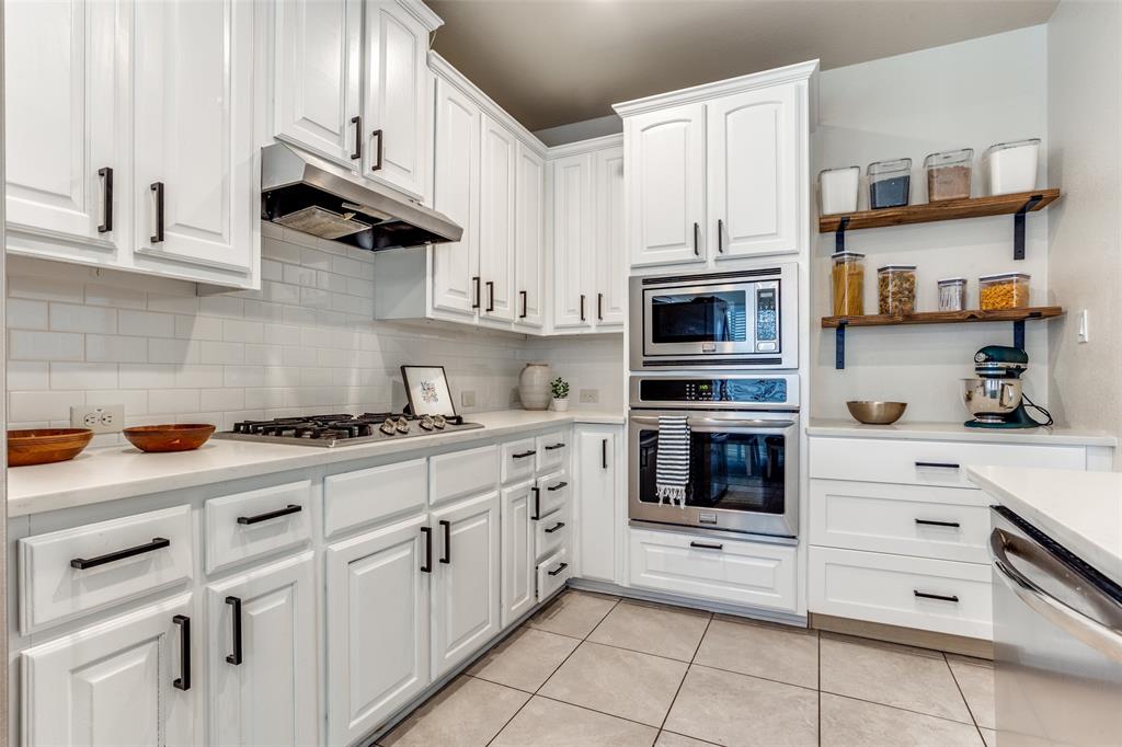 a kitchen with cabinets stainless steel appliances and a counter space