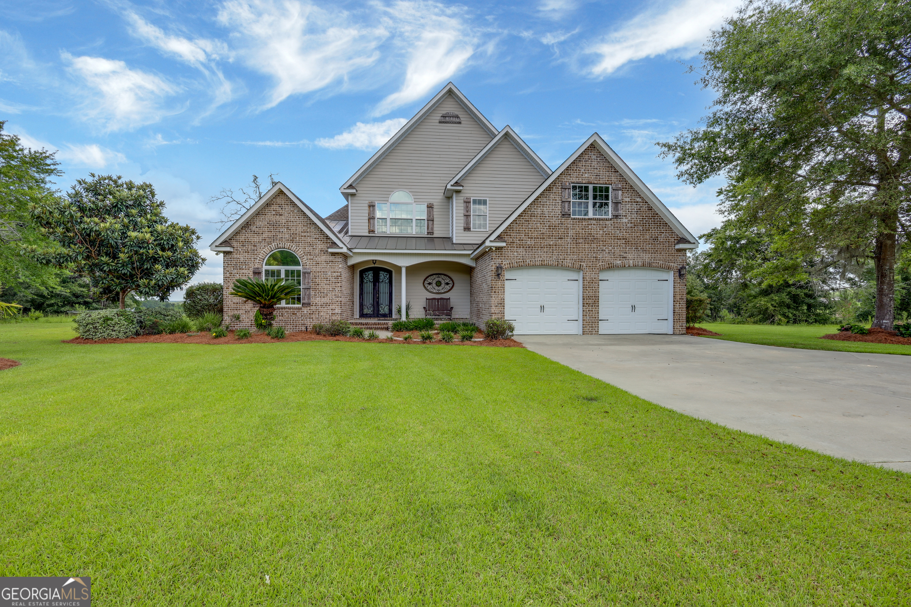 a front view of house with yard and green space