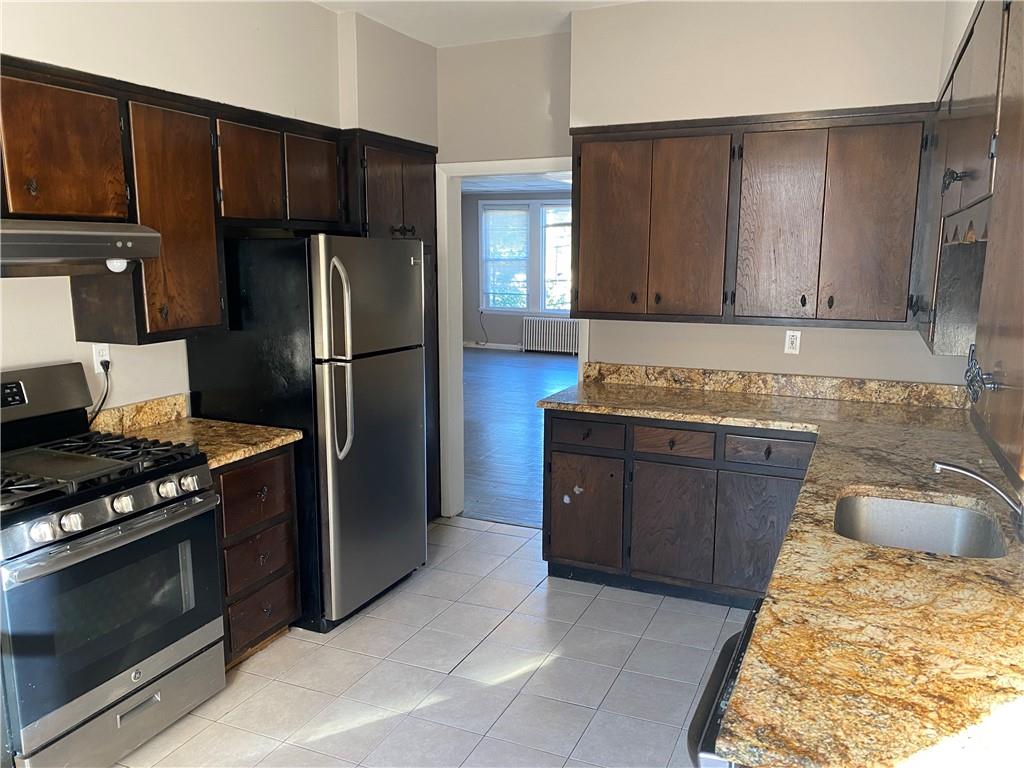 a kitchen with a refrigerator stove and cabinets