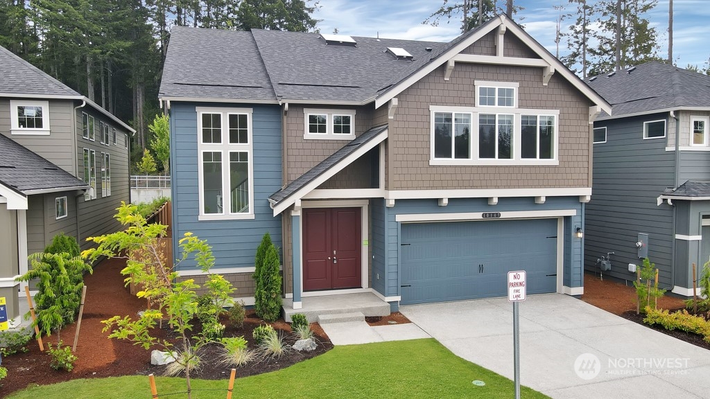 a front view of a house with a garden and plants