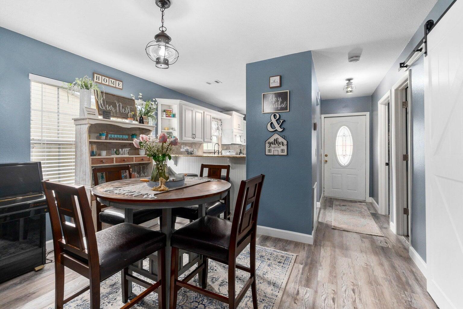 a view of a dining room with furniture and wooden floor