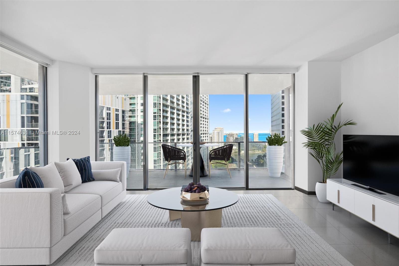 a living room with furniture a flat screen tv and a large window