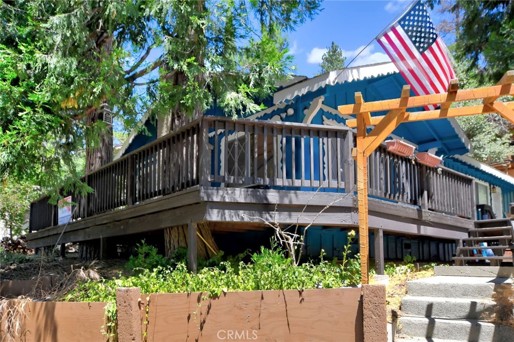 a view of a house with a small yard and wooden fence