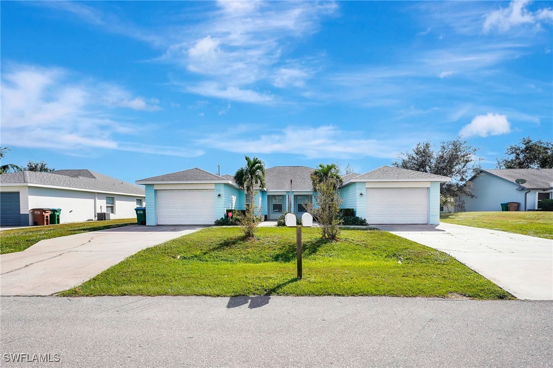 a front view of a house with a yard and garage