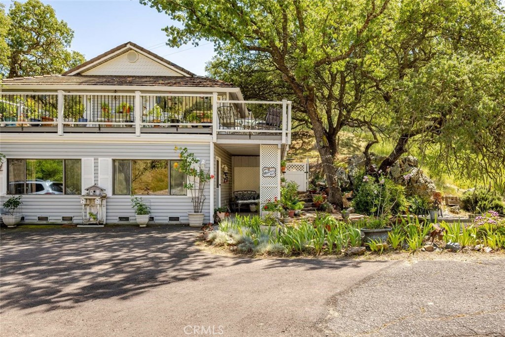 a front view of a house with a yard and potted plants