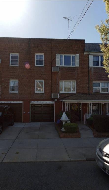 a front view of a house with parking space