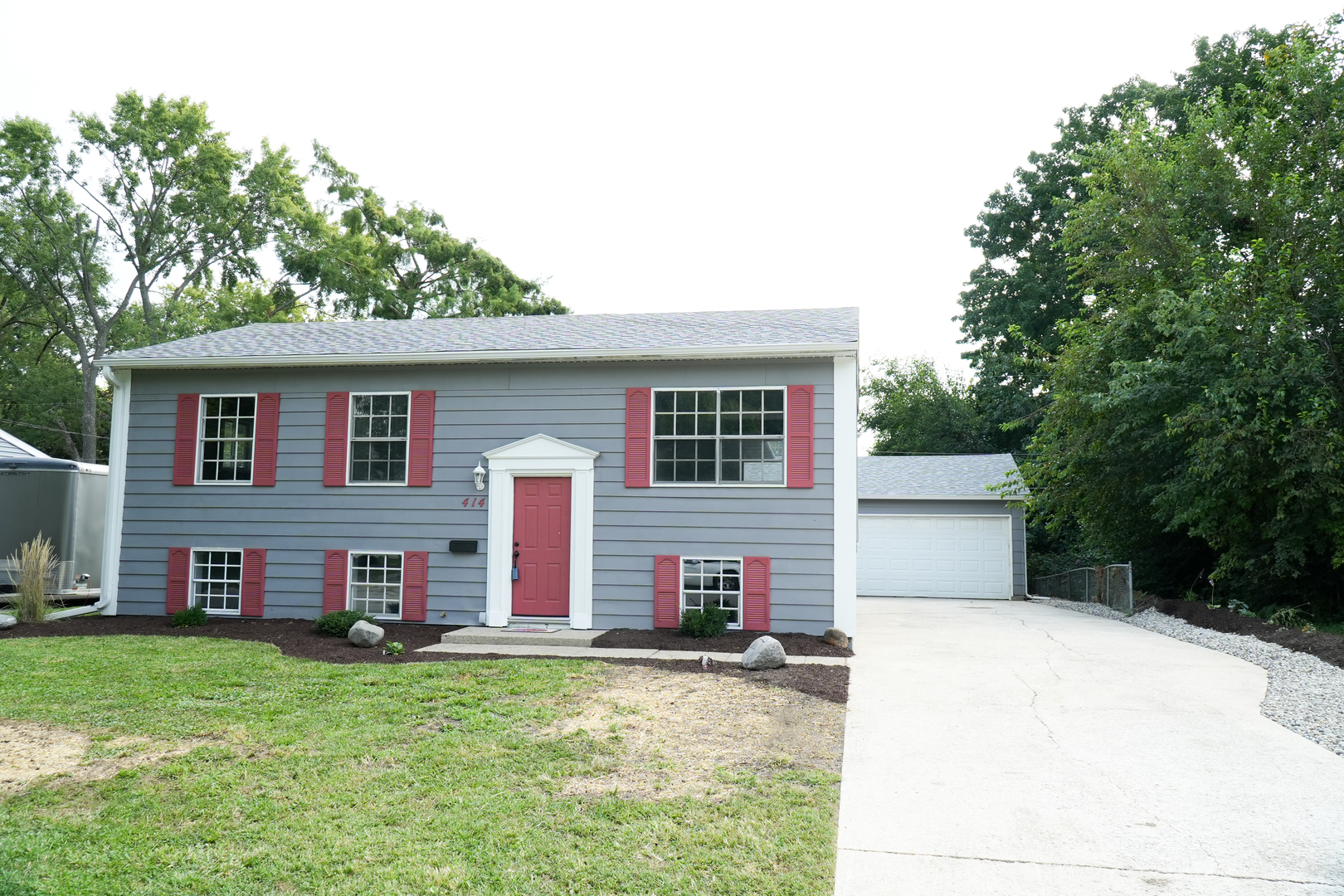 a front view of house with yard and trees