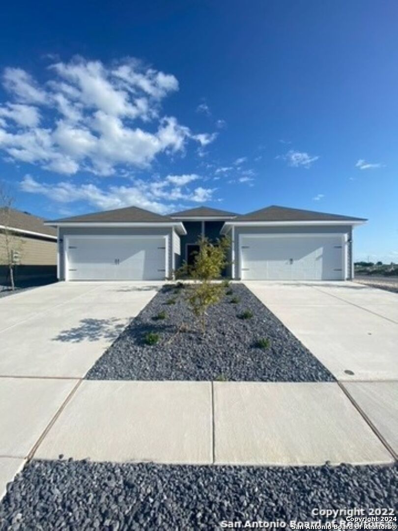 a front view of a house with garage