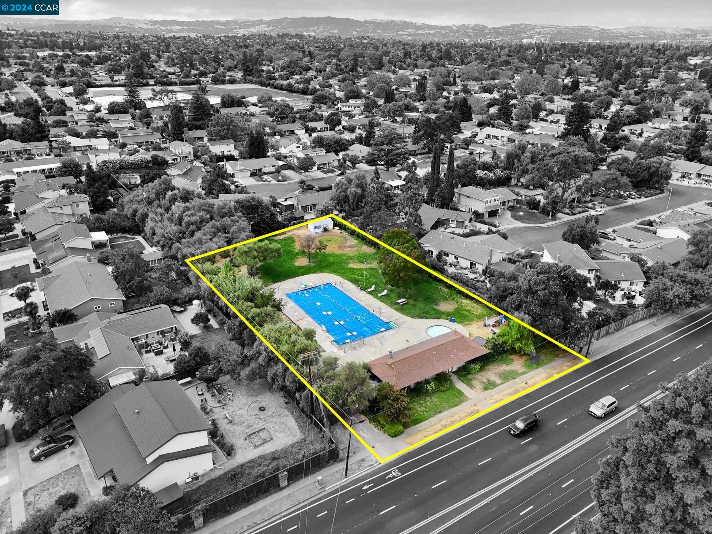 an aerial view of a residential houses with a city view