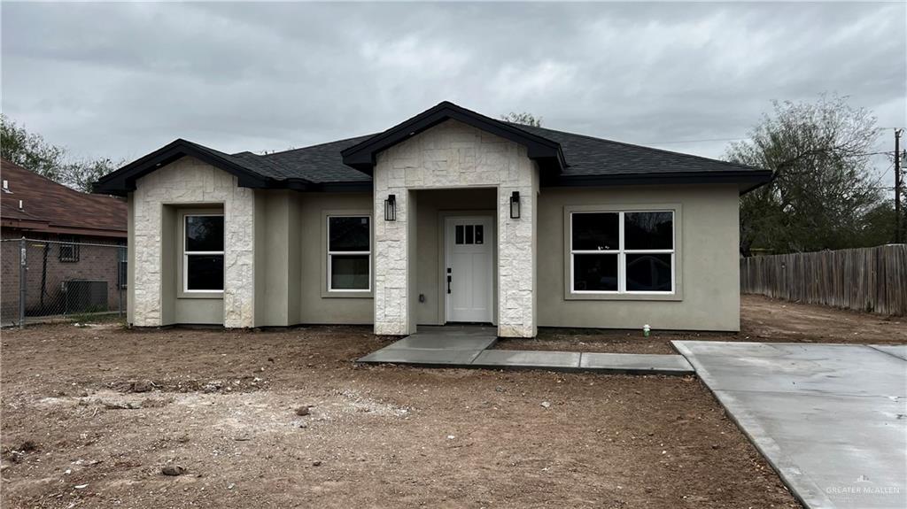 View of front of property with cooling unit