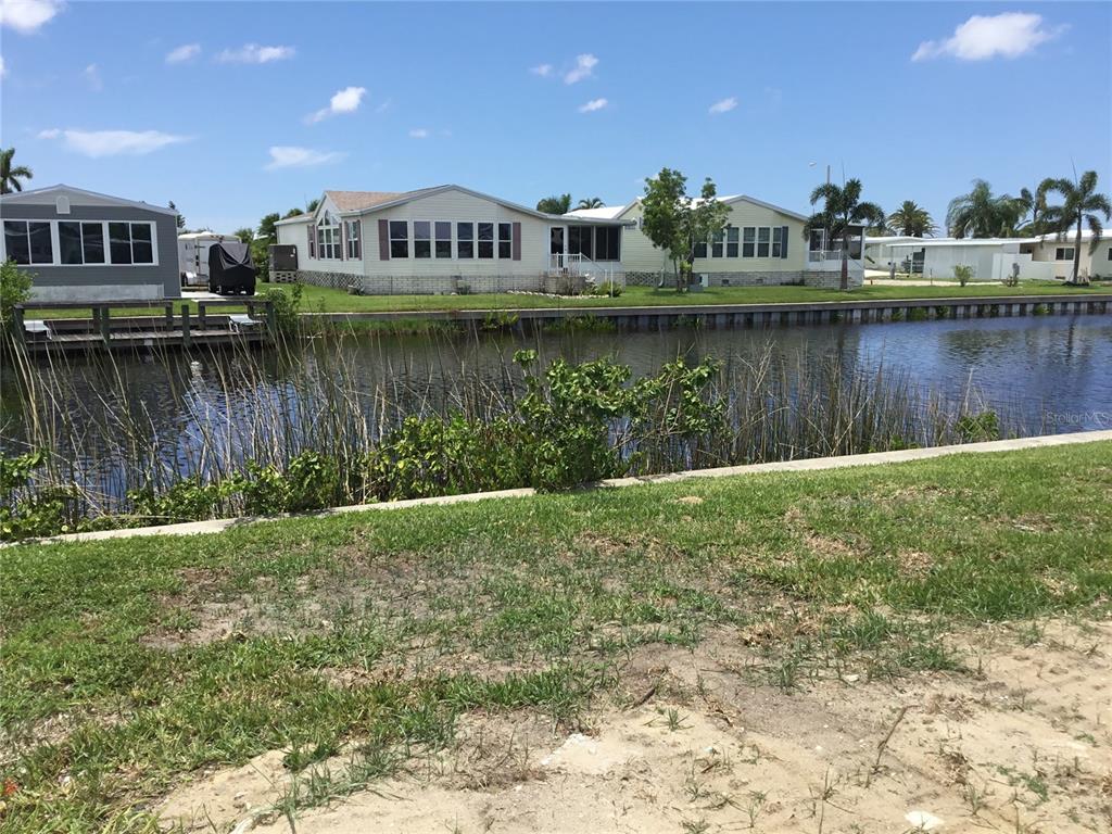 a view of a large house with a lake view