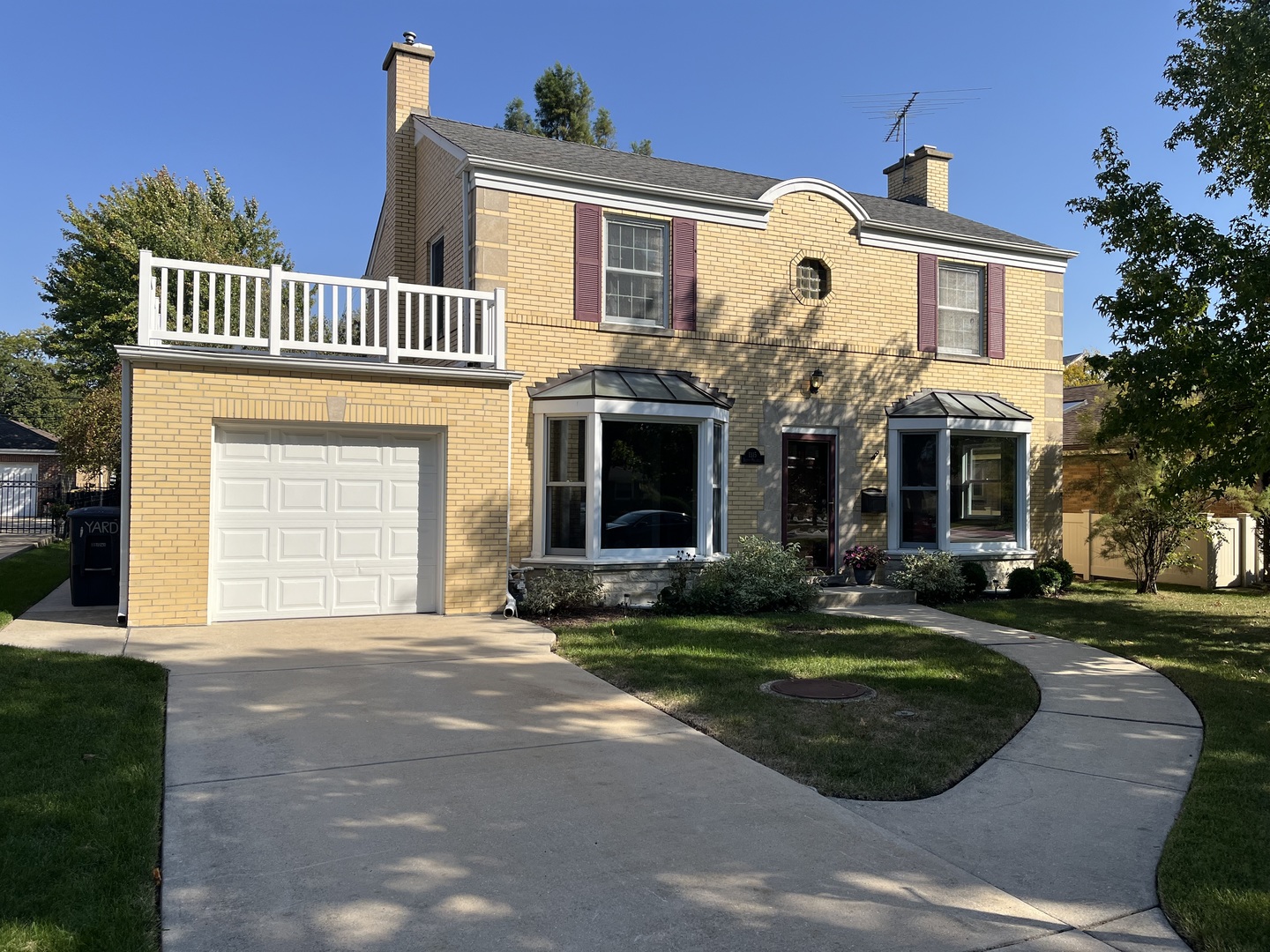 a front view of a house with yard and green space