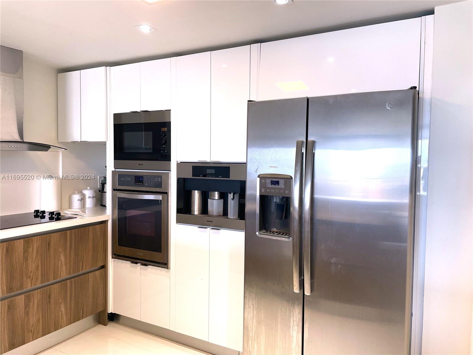 a kitchen with stainless steel appliances a refrigerator and a stove