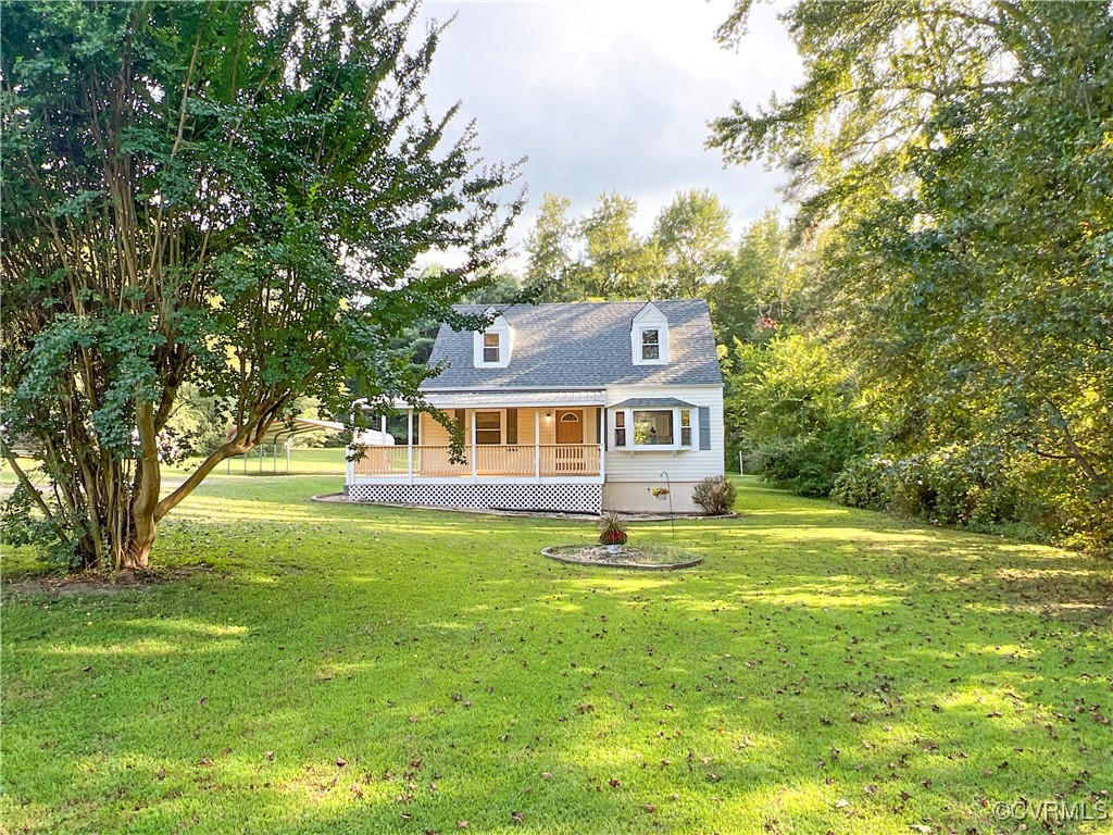 a front view of a house with yard and green space