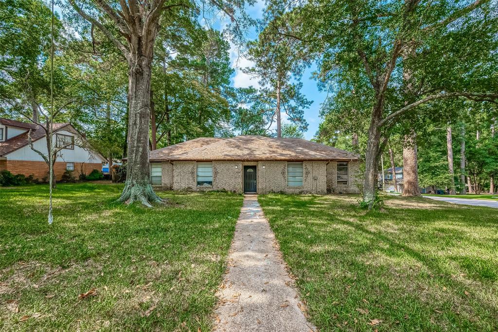 a front view of a house with yard patio and green space