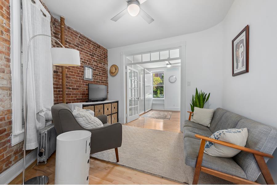 a living room with furniture and a potted plant