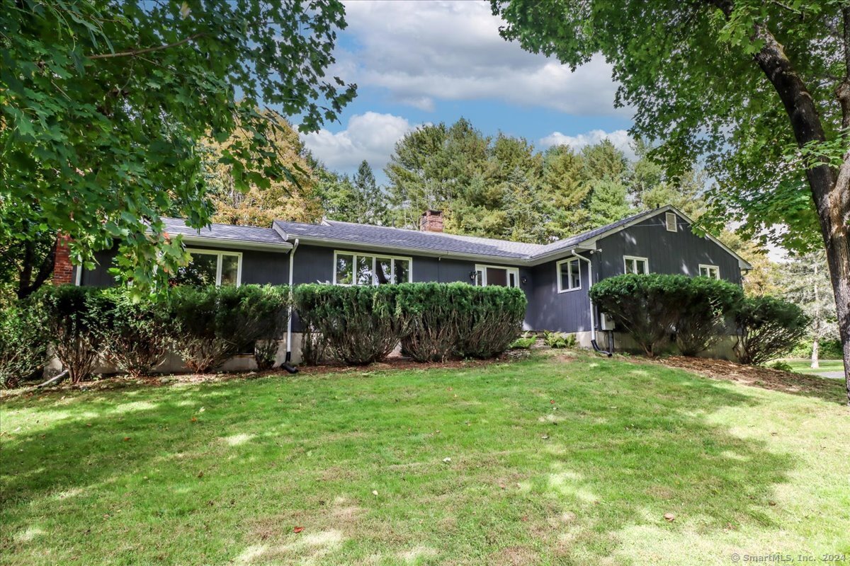 a view of a house with a yard and plants