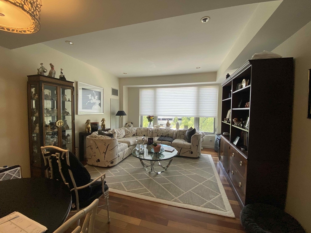 a living room with furniture a window and gym equipment