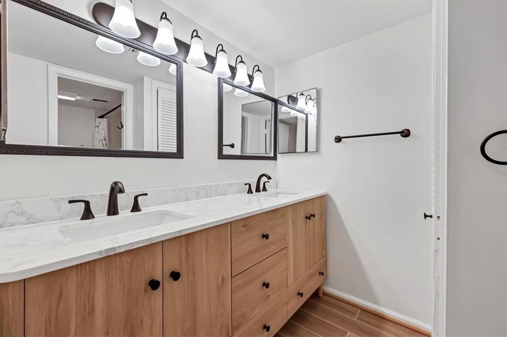 a bathroom with a double vanity sink mirror and