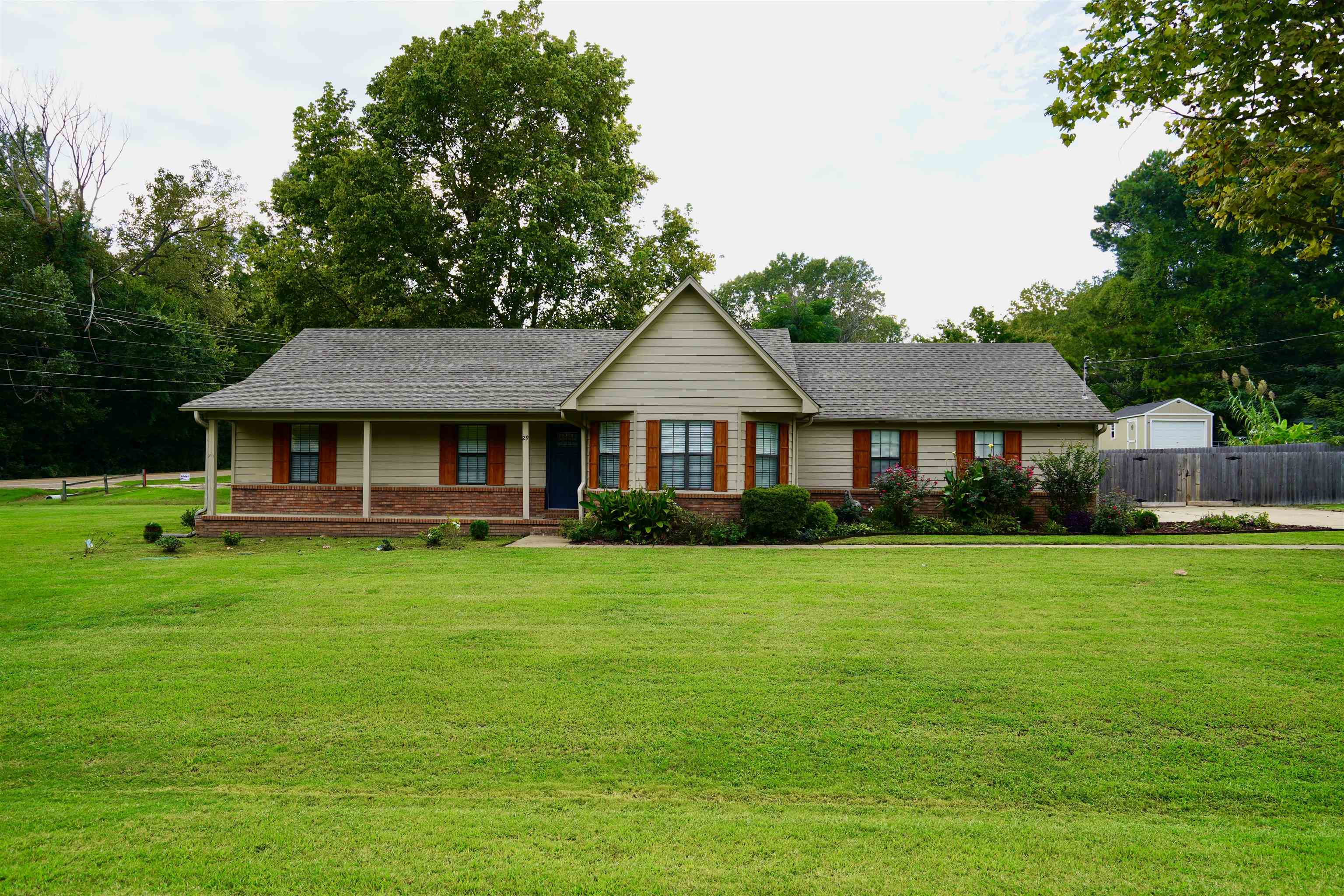 a front view of a house with a garden