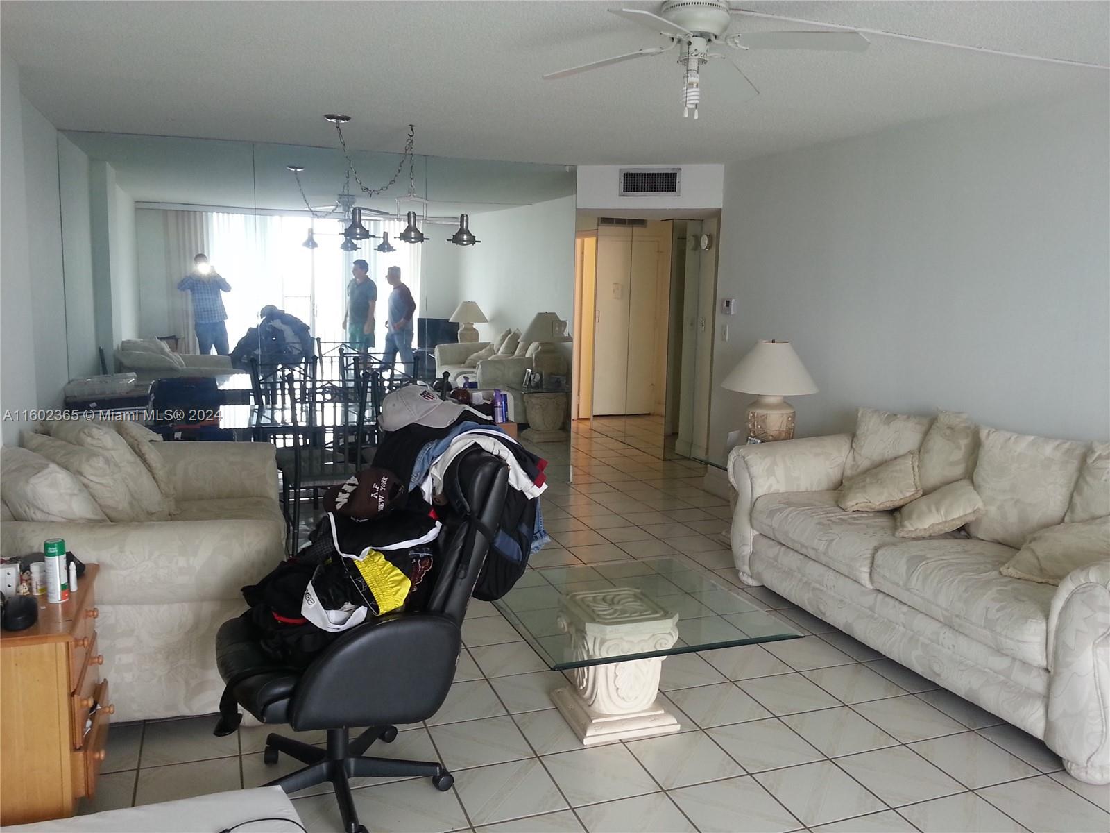 a living room with couches and chandelier