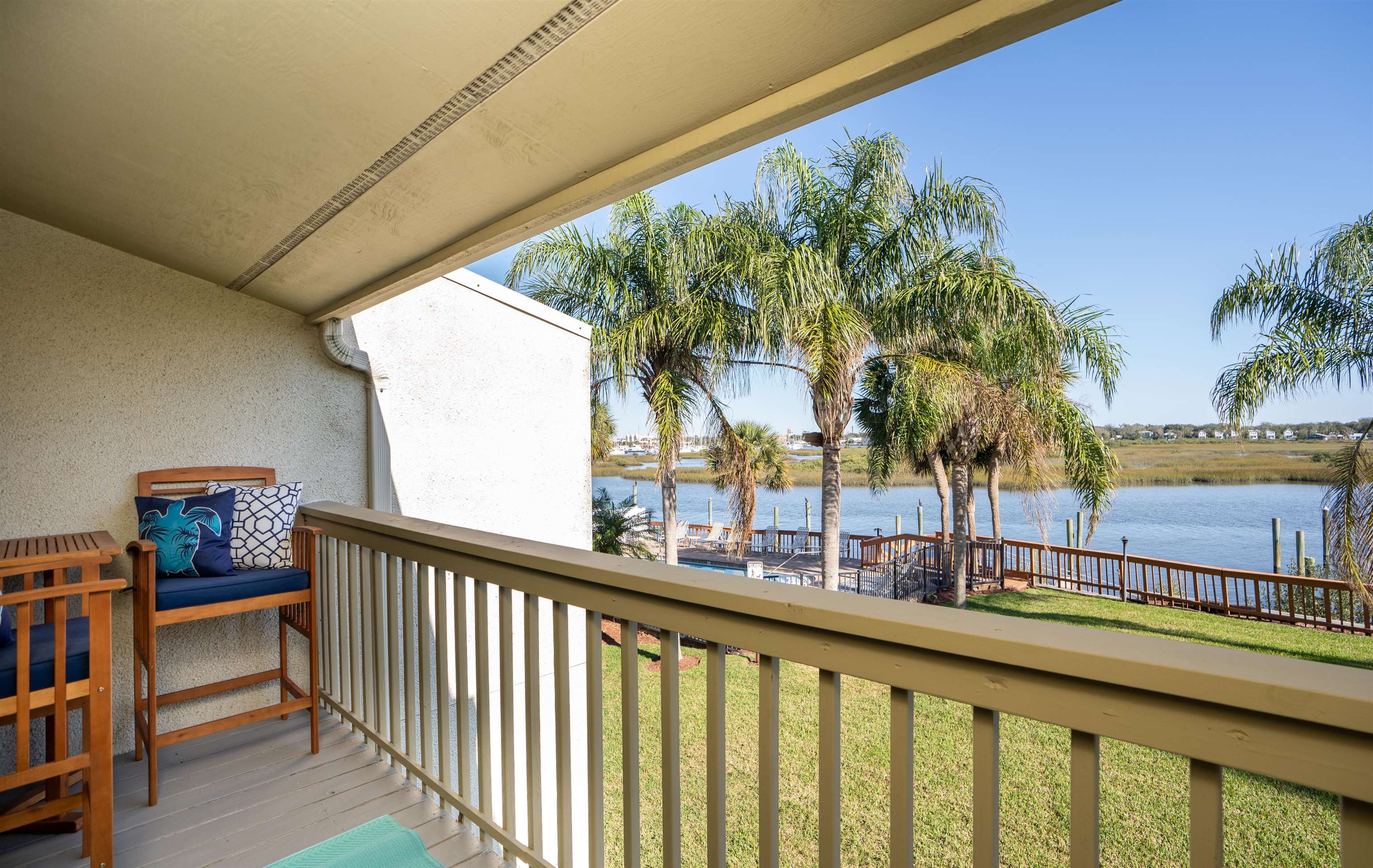 a view of balcony with two potted plants and palm trees