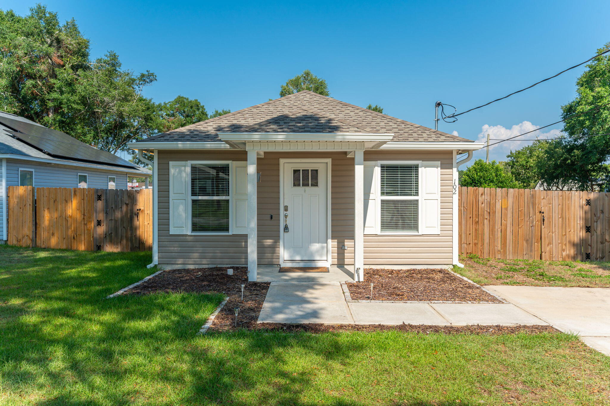 a front view of a house with a yard and porch