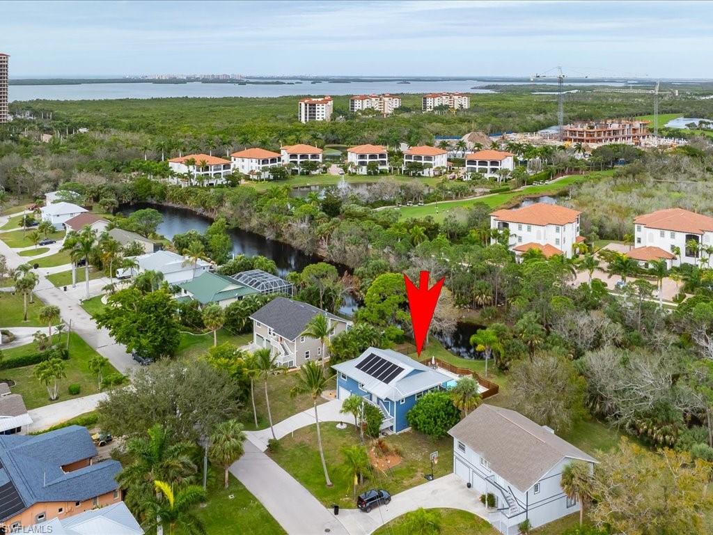 an aerial view of residential houses with outdoor space and river