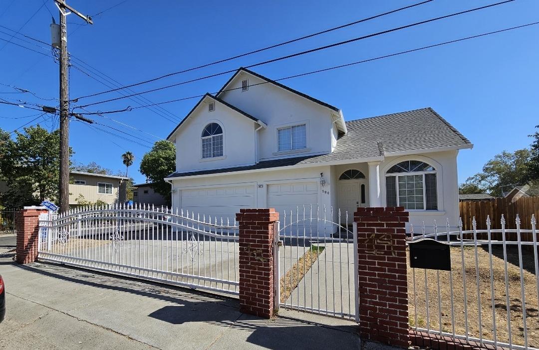 a front view of a house with iron fence