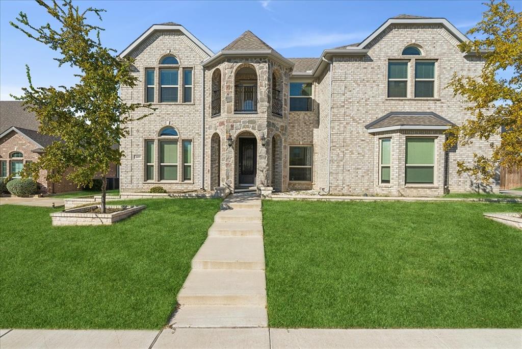 a front view of a house with a yard