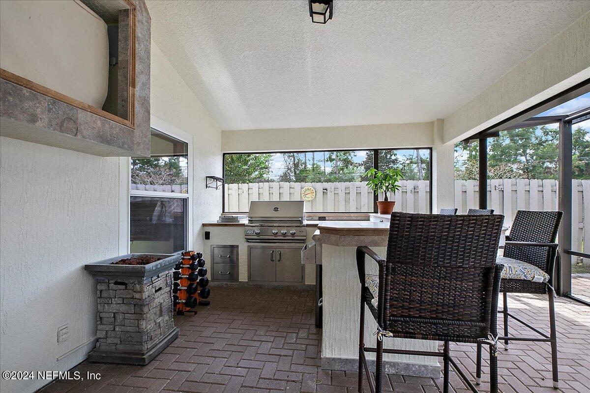 a dining room with furniture and large windows