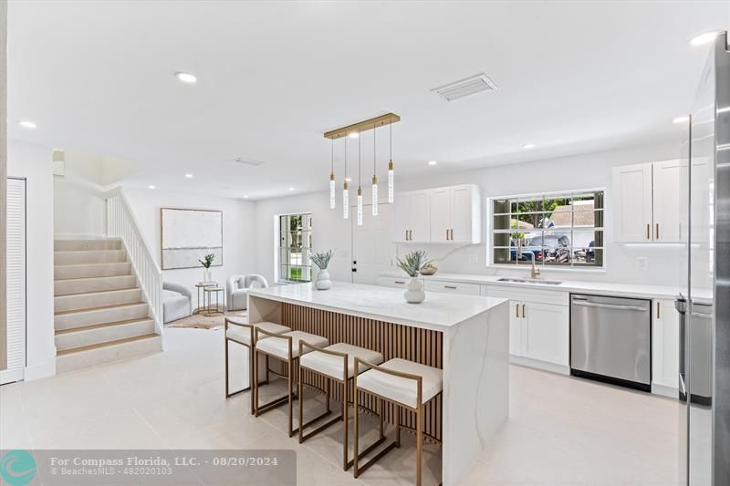 a kitchen with white cabinets and white appliances