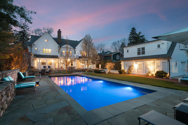 a view of a swimming pool with a table and chairs