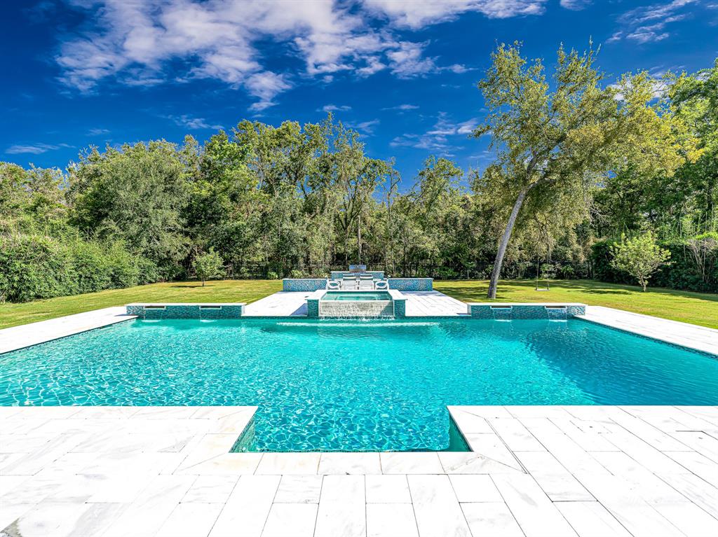 a view of a swimming pool with a yard