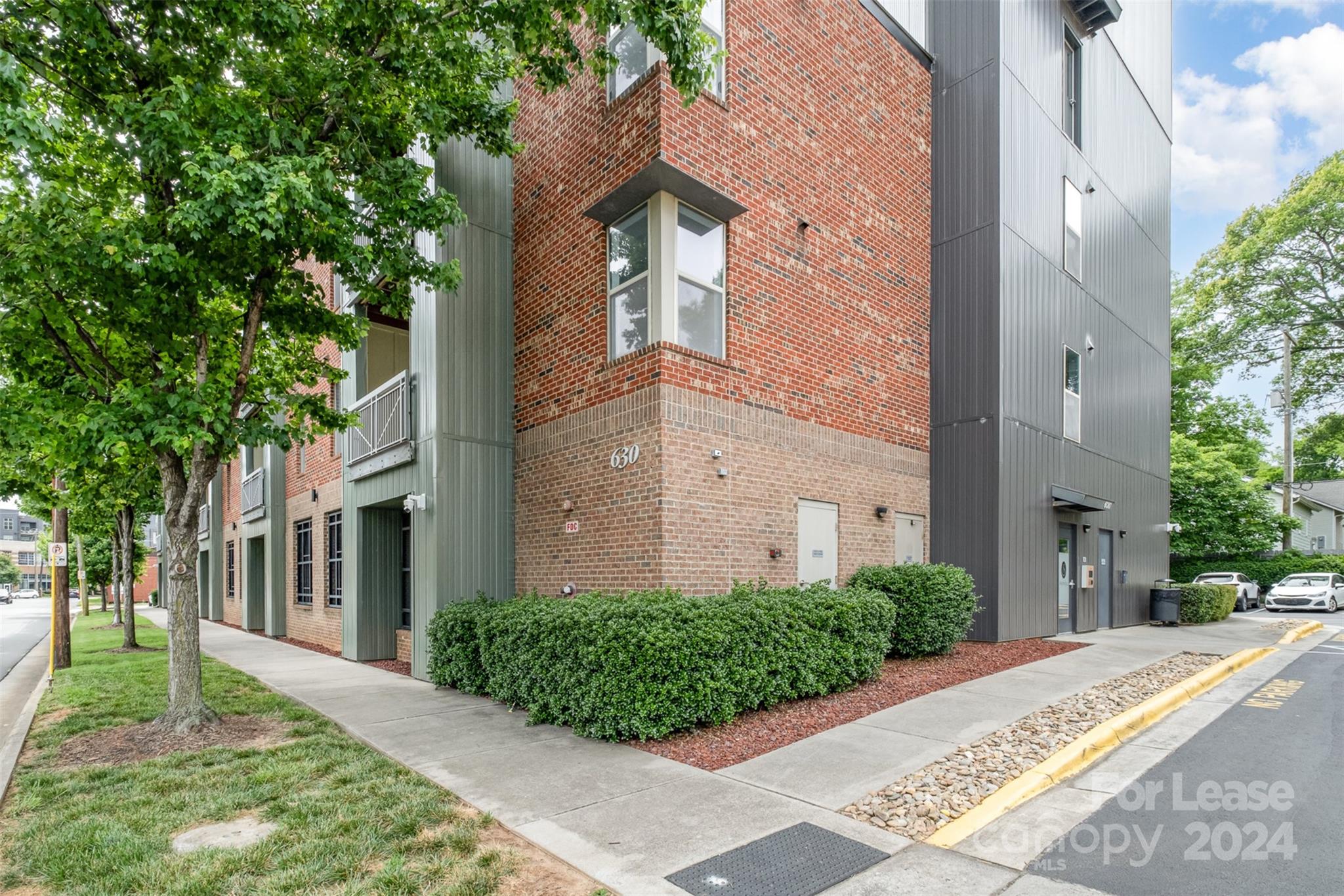 front view of a brick house with a yard