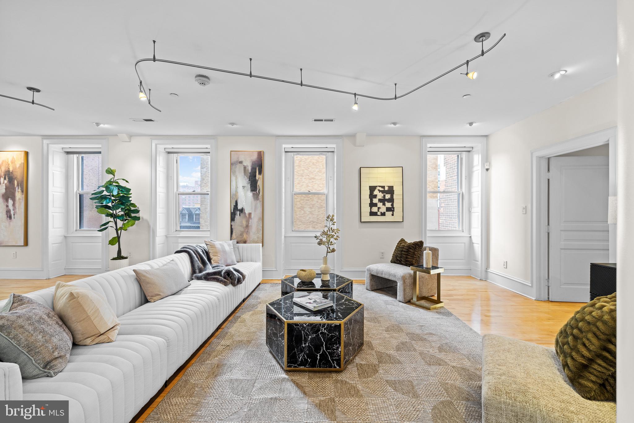 a living room with furniture and wooden floor