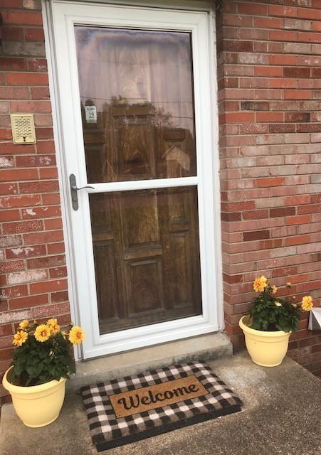 a view of a door of the house with chair