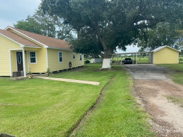 a view of a house with a yard and tree s