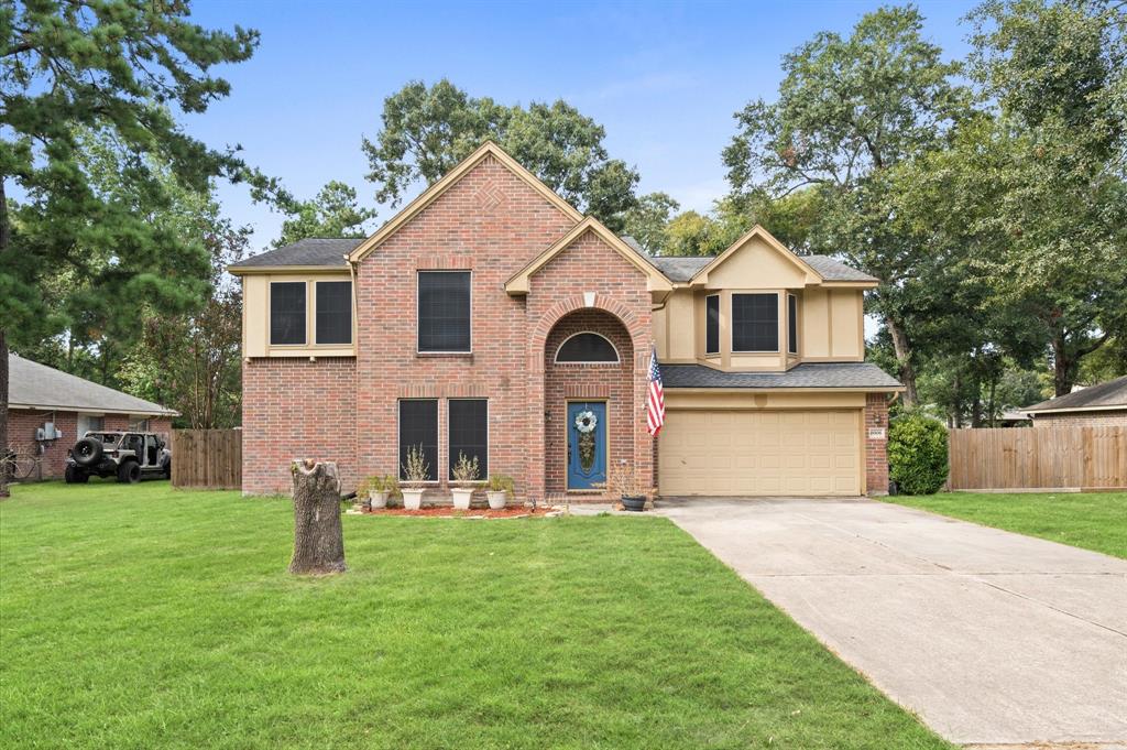 a front view of house with yard and green space