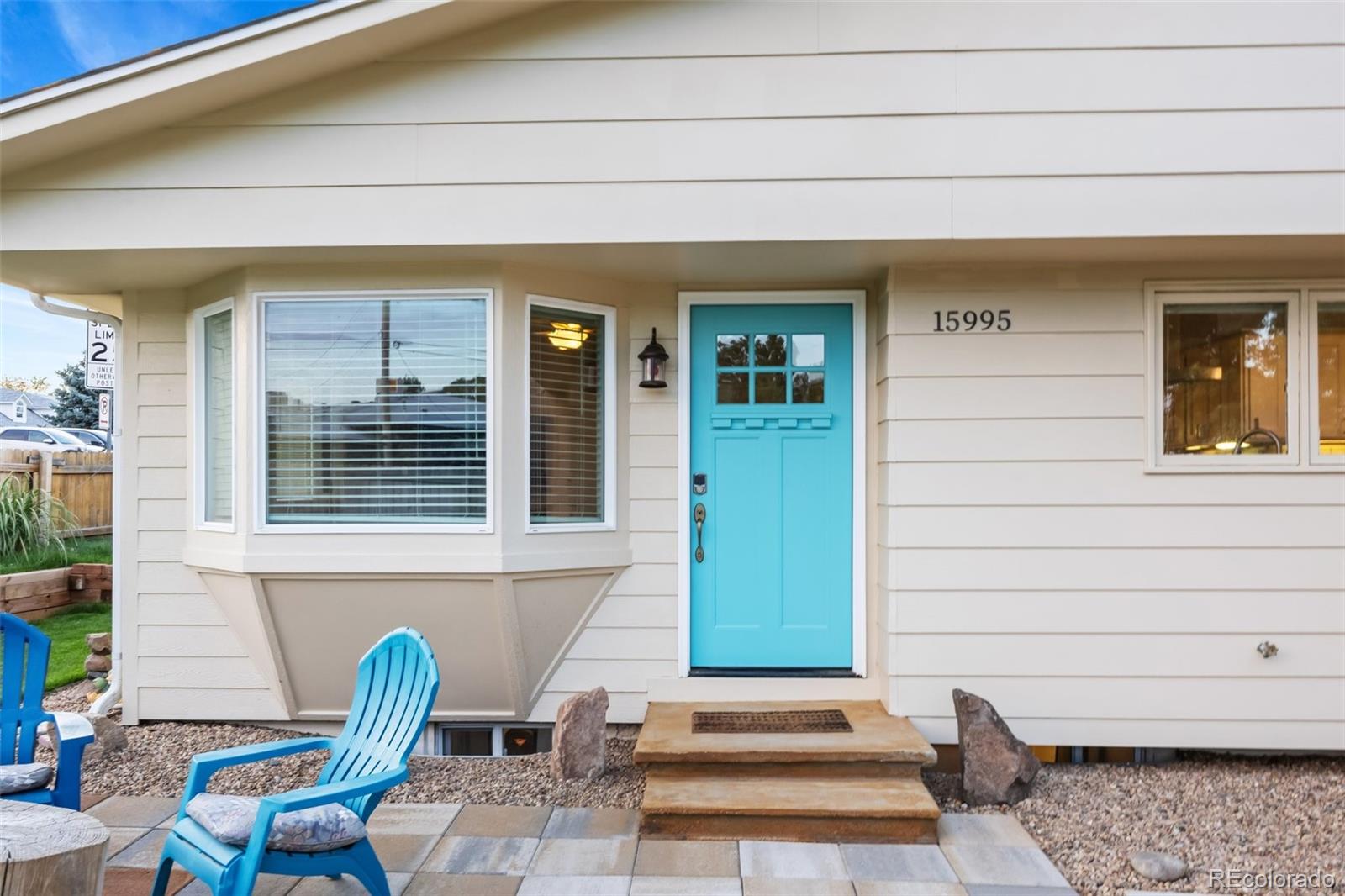 a front view of a house with outdoor seating