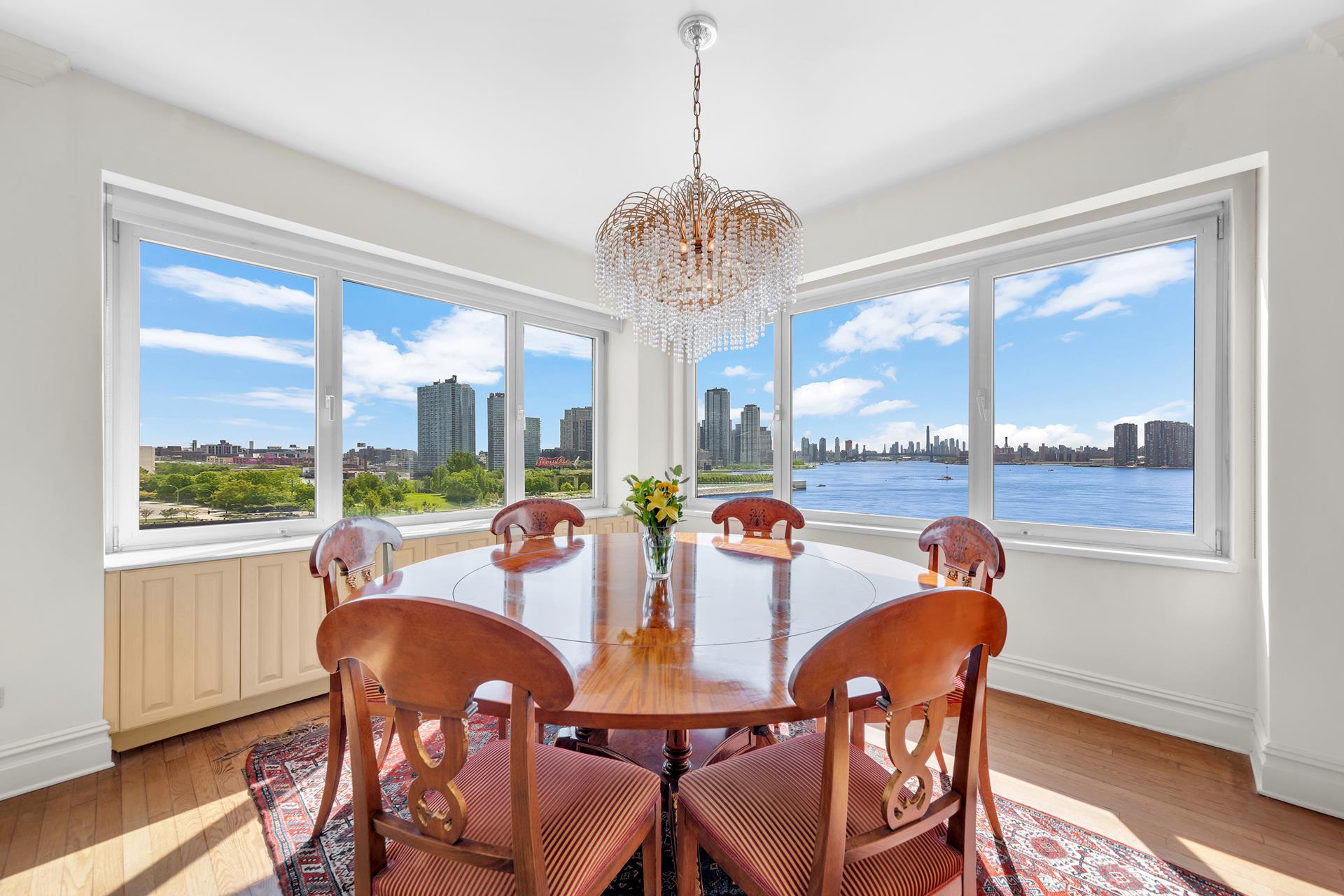 a view of a dining room with furniture large windows and wooden floor