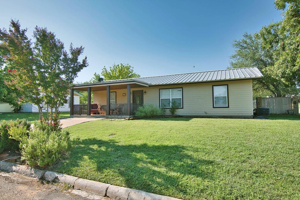 a front view of house with yard and outdoor seating