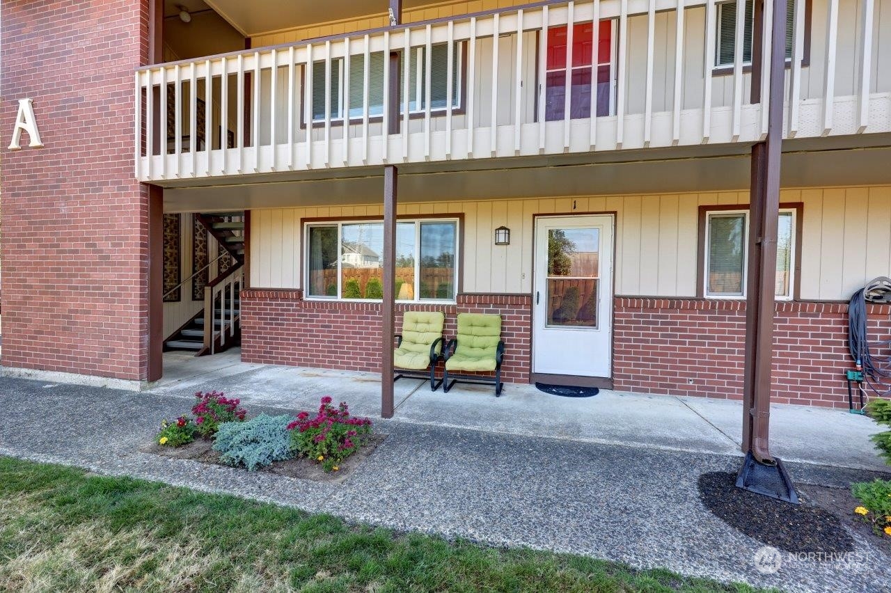 a view of a house with a yard and sitting area