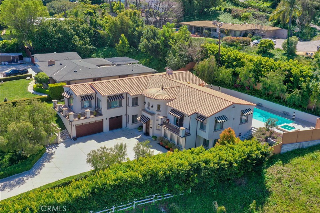 an aerial view of a house with garden space and street view