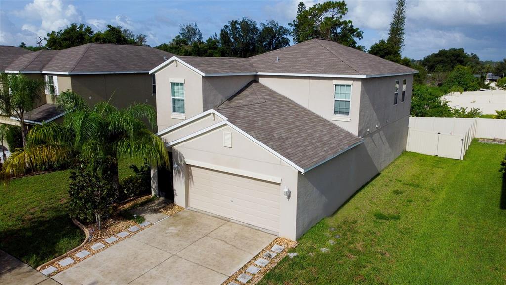 an aerial view of a house with a yard