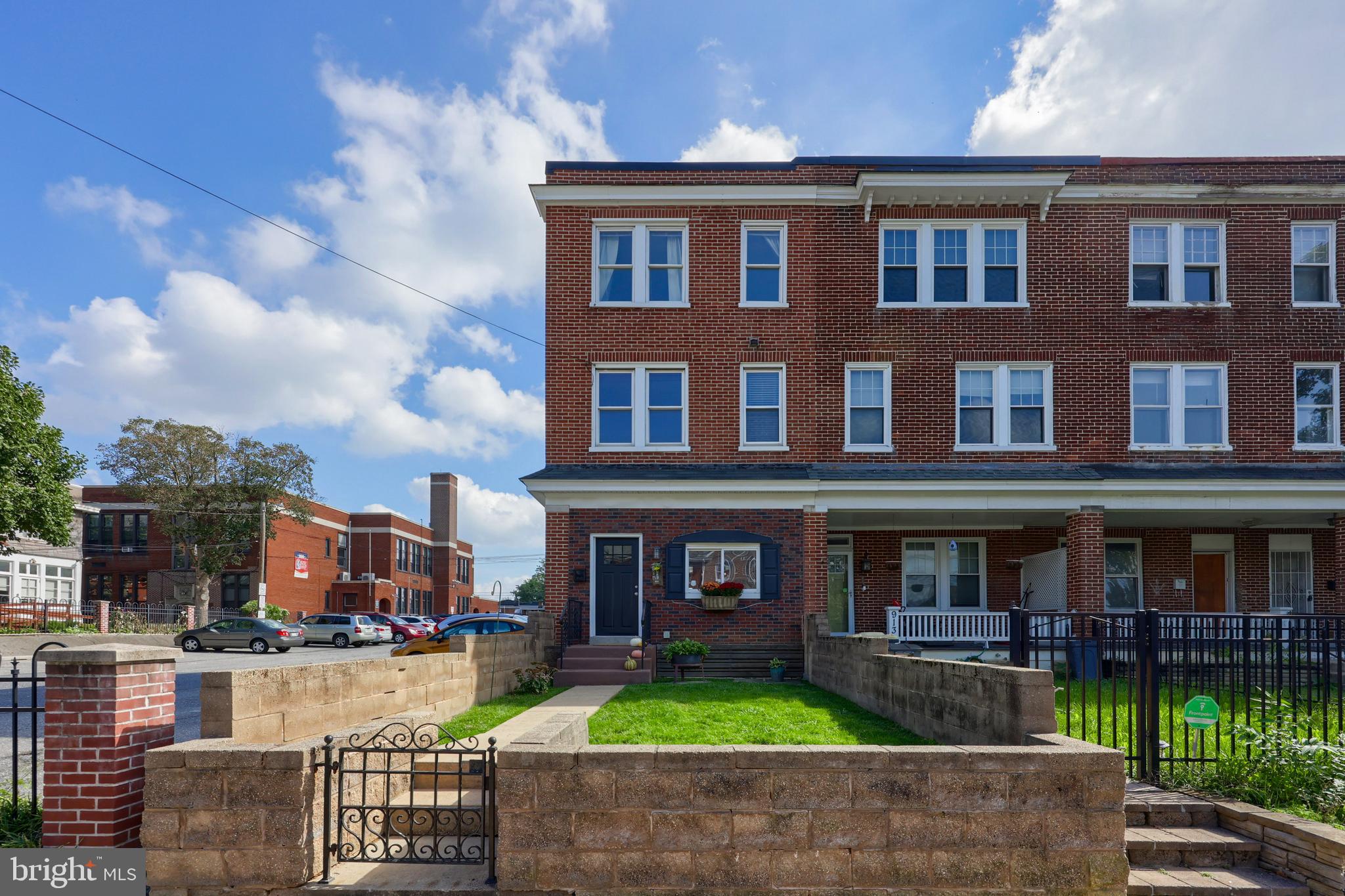 a front view of brick house with a yard