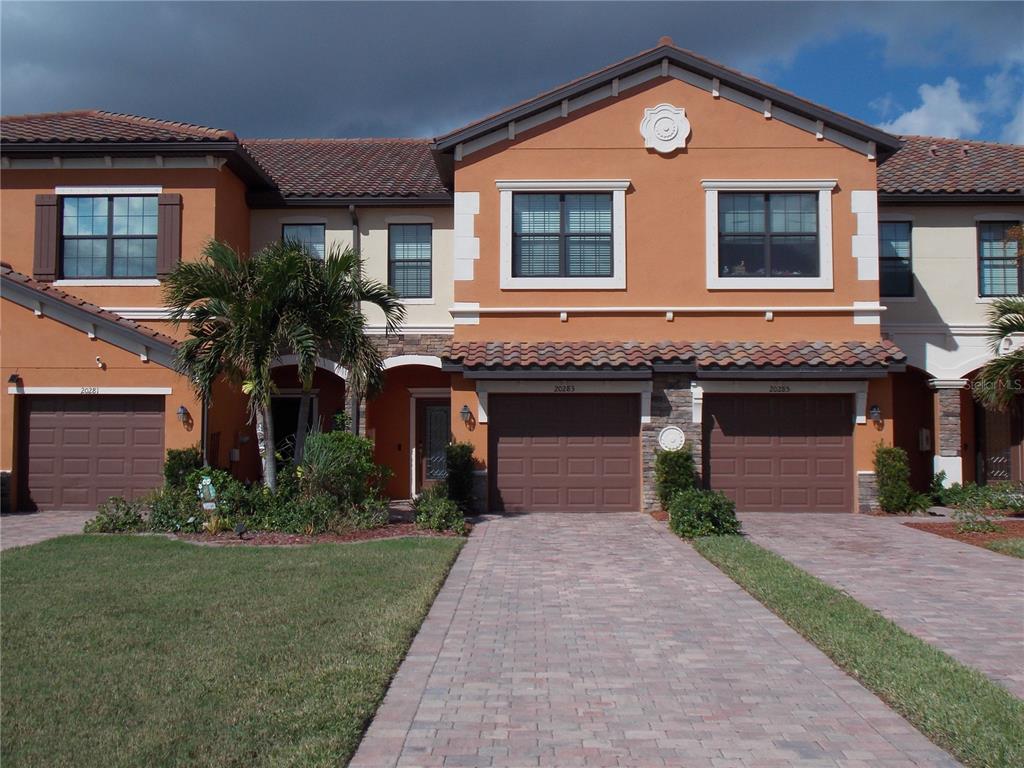 a front view of a house with a yard and garage