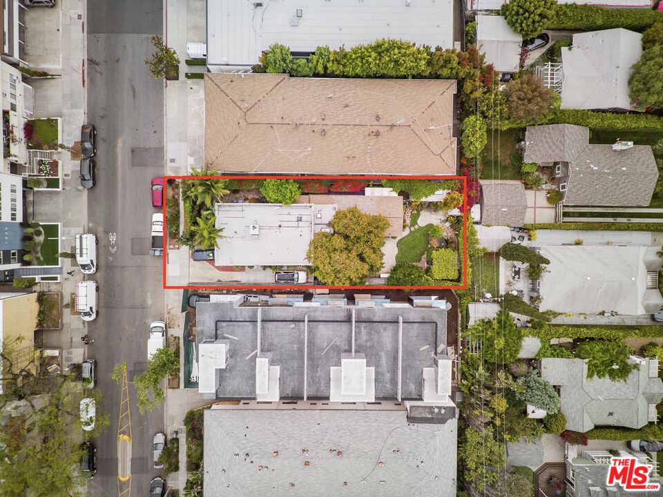 an aerial view of a houses with yard