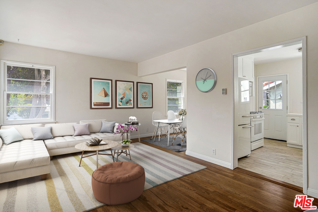 a living room with furniture and wooden floor