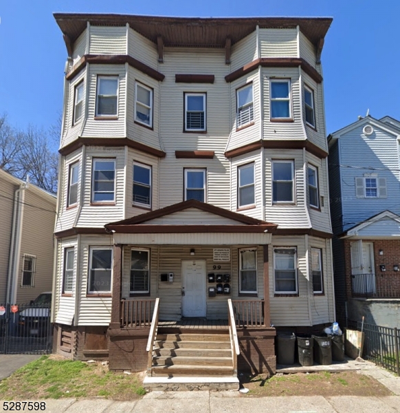 a front view of a residential apartment building with a yard